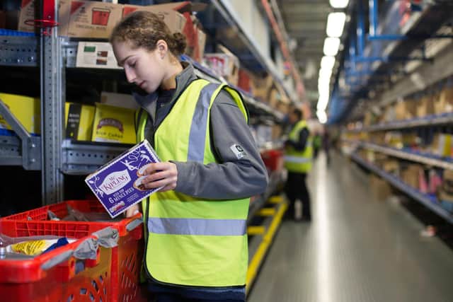 A staff member packing food for delivery Picture: Daniel Leal-Olivas/PA Wire