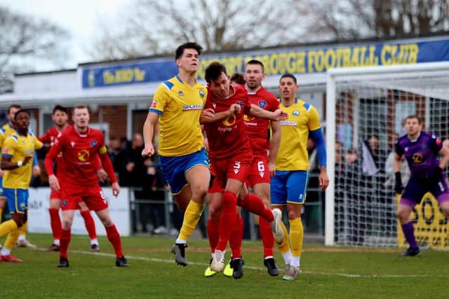 Gosport defender Finn Walsh-Smith, centre left, heads clear. Picture by Tom Phillips
