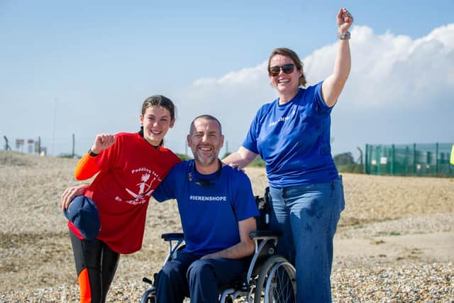 12-year-old Seren Killpartrick from Fareham is paddleboarding from the Isle of Wight to Stokes Bay to raise money for brain tumour treatment for her dad.Pictured: Seren Killpartrick with her mum, Rhian and Paul at Stokes Bay beach on Thursday 16th September 2021Picture: Habibur Rahman