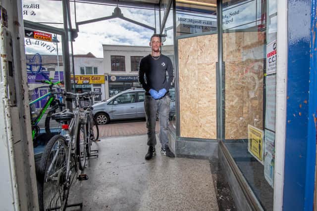 John Partridge next to the damaged front of Town Bikes
Picture: Habibur Rahman