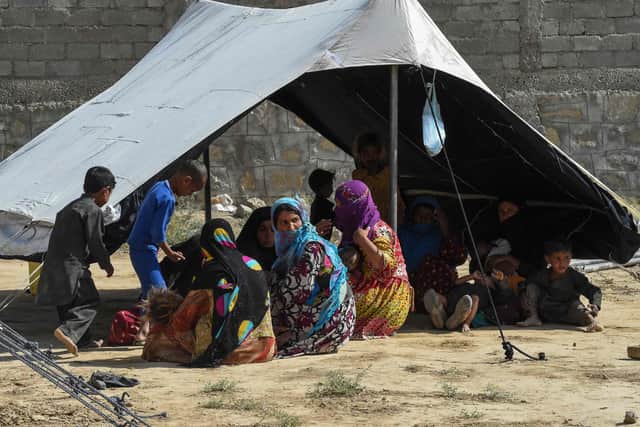 Afghan refugees sit around a makeshift tent shelter on the outskirts of Quetta Picture: Banaras Khan/AFP via Getty Images