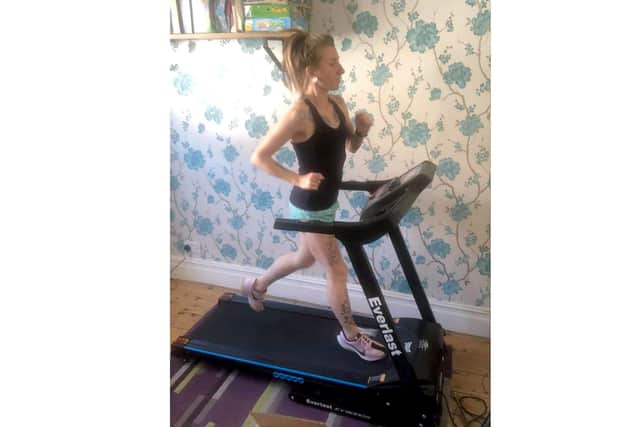 Katrina Fry, 32 from Milton, training to run the distance of the London Marathon on the treadmill in her living room.