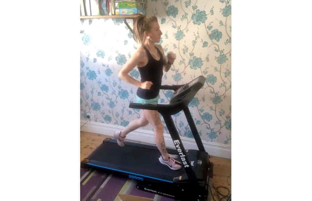 Katrina Fry, 32 from Milton, training to run the distance of the London Marathon on the treadmill in her living room.