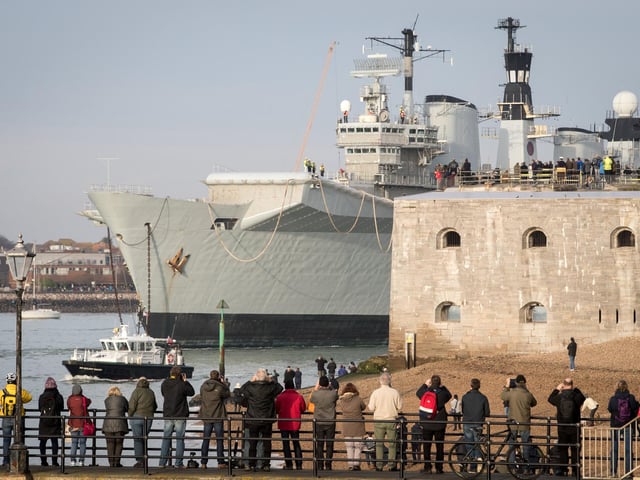 People watched as Britain's last serving aircraft carrier HMS Illustrious was towed from her home port at Portsmouth after being sold for scrap on December 7, 2016 in Portsmouth. 'Lusty' was to be broken up for scrap in Turkey despite attempts last minute attempts to save her. Photo by Matt Cardy/Getty Images