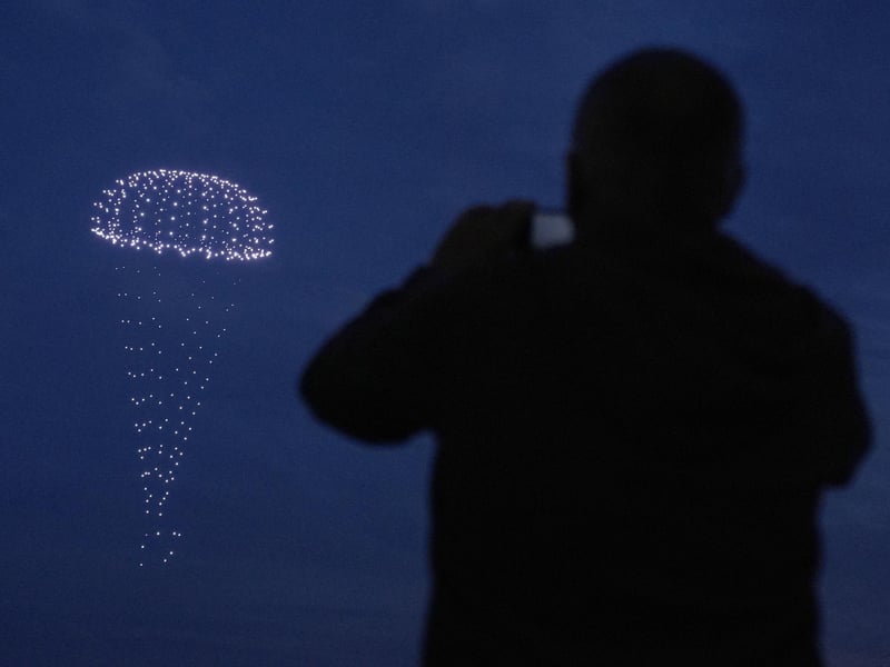 Drones make a parachute during a drone display telling the story of D-Day. Photo: Andrew Matthews/PA Wire