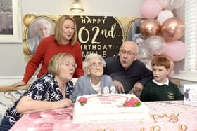 Pictured is: (middle) Millie Bucksey with some of her family (l-r) Sue Bucksey, daughter-in-law, Stefanie Marrison, granddaughter, Mervyn Bucksey, son, and Samuel Marrison, great grandson, help Millie blow out her candles. Picture: Sarah Standing (200224-7126)