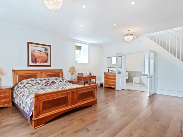 The listing says: "Set within grounds approaching one acre (incl. Bank) this incredible home of over 7,000 sq. Ft (inc outbuildings) provides flexible living accommodation for the discerning purchaser."