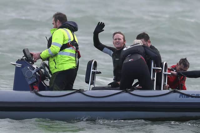 Former paratrooper John Bream (centre) waves to the press boat after setting the record for highest jump without a parachute by jumping 40m from a helicopter off Hayling Island in Hampshire.Andrew Matthews/PA Wire