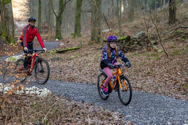 Emily Wing, 10, tests the new mountain bike trail in Queen Elizabeth Country Park watched over by dad Dave Wing, 39 Picture: Mike Cooter (210123)