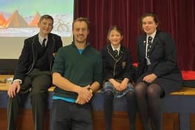 Record breaking explorer, George Bullard, alongside children from Boundary Oak School.