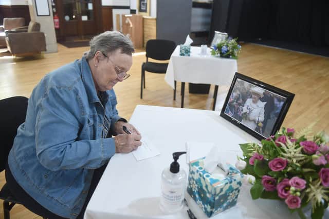 Lesley Knight (77) from Milton, sending a message of condolence to Queen Elizabeth II in Portsmouth Guildhall.

Picture: Sarah Standing (120922-3212)