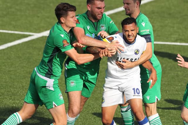 Hawks sub Billy Clifford clashes with Oxford players after a foul for which he was booked. Picture by Dave Haines)