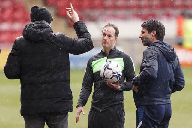Referee Martin Coy, centre, with Danny Cowley and Crewe boss David Artell, ahead of calling off Saturday's Gresty Road encounter. Picture: Daniel Chesterton/PinPep