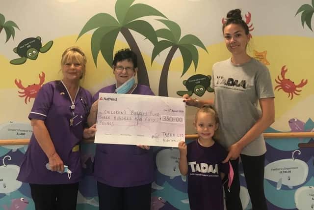 Helen Wallis has been raising money throughout lockdown for Queen Alexanda Hospital by offering her performing arts classes online and people could give a small donation, as well as performing on her drive during VE Day. Pictured: l-r Sue Richardson and Anne Ricketts, play specialists, Brooke Wallis (five) and Helen Wallis