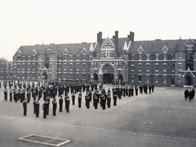 This is a view of Divisions on Victoria Barracks parade ground in 1954. This vista is from the Duchess of Kent Barracks and we see sailors and wrens standing to attention.