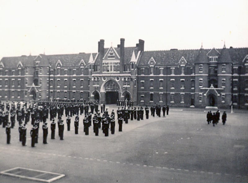 This is a view of Divisions on Victoria Barracks parade ground in 1954. This vista is from the Duchess of Kent Barracks and we see sailors and wrens standing to attention.