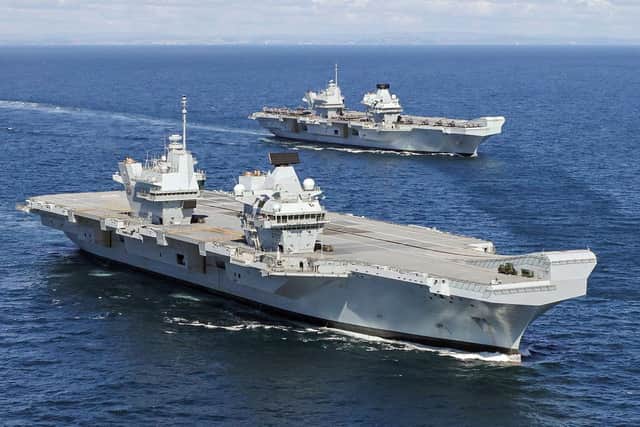 HMS Prince of Wales, front, pictured for the first time at sea with her sister ship HMS Queen Elizabeth, rear.