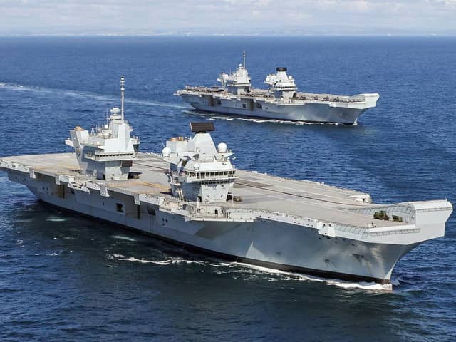 HMS Prince of Wales, front, pictured for the first time at sea with her sister ship HMS Queen Elizabeth, rear.