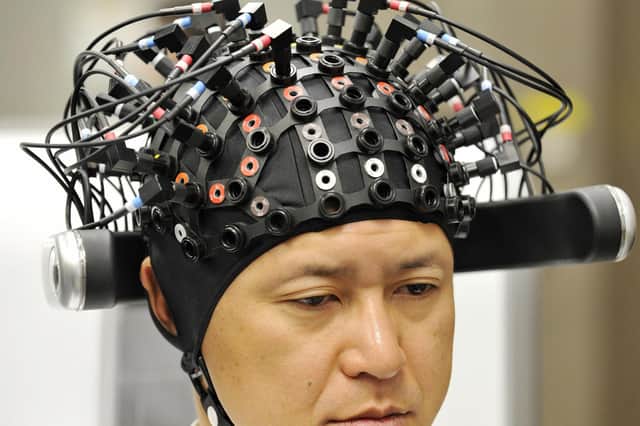 A man wears a brain-machine interface, equipped with electroencephalography (EEG) devices at Japanese auto giant Honda's headquarters in Tokyo on March 31, 2009. 
Picture: Yoshikazu Tsuno/AFP via Getty Images
