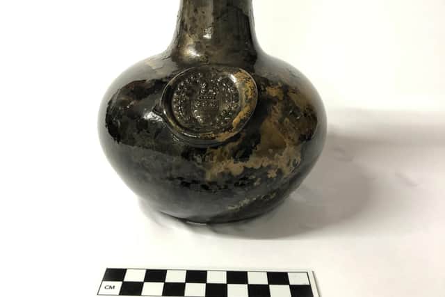 One of the bottles found with the wreck, which bears a glass seal with the crest of the Legge family who are ancestors of George Washington, the first US President. Picture: Norfolk Historic Shipwrecks/PA Wire