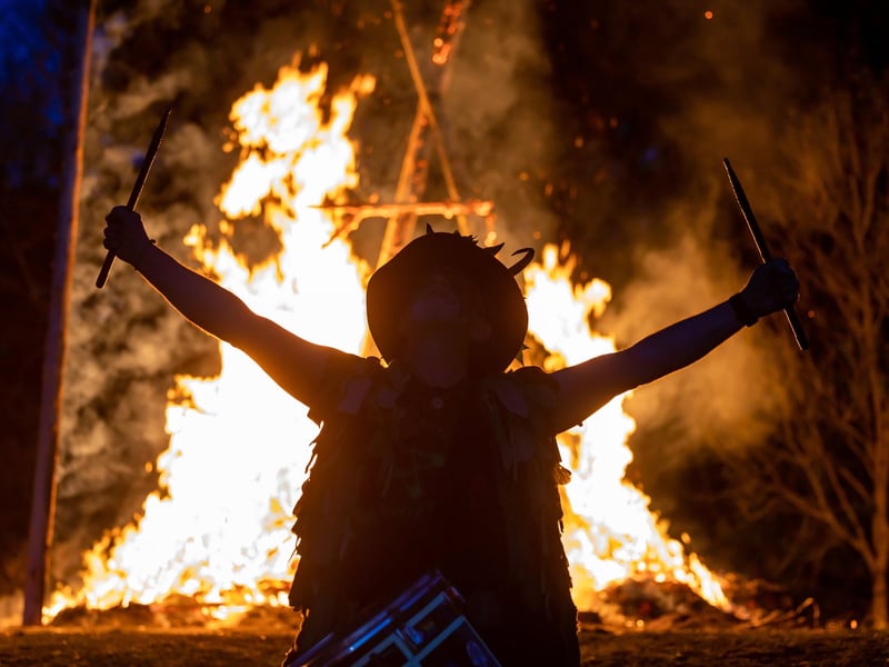 Adam Granger - leading the Pentacle Drummers - at the climax of the Beltain celebrations with the burning wickerman in the background.