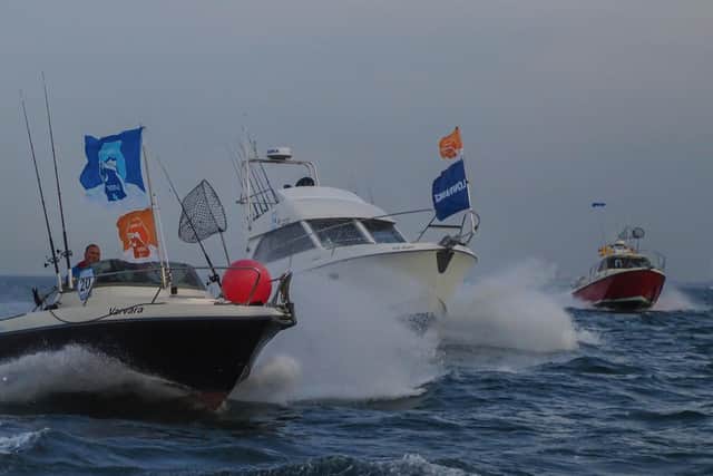 Boats race for prime positions at the start line for the Sea Angling Classic
