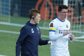 Paul Rooney leaves the pitch before half-time accompanied by Hawks physio Jake Travis. Picture: Dave Haines)