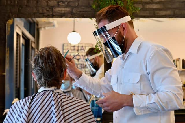 Hairdressers will have to wear face visors under new government guidelines. Picture: ANGELA WEISS/AFP via Getty Images