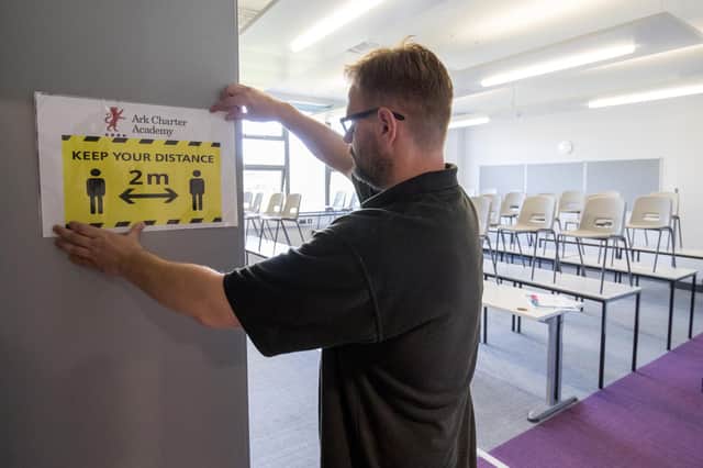 A social distancing sign is put up in a classroom at Ark Charter Academy in Portsmouth, as preparations are made before the start of the new term. PA Images