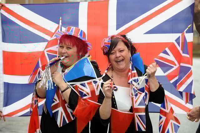 U-Need-Us staff members (l-r) sisters Karen Knipe and Tracey Knipe get the street party started outside the store in February 2011. Picture: Allan Hutchings (110573-296)