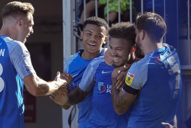 Josh Koroma is congratulated by his Pompey team-mates following his first-half opener against Plymouth. Picture: Barry Zee