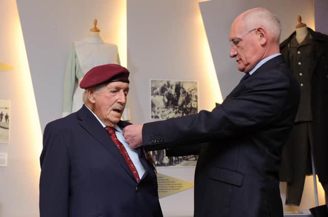 Arthur Bailey is presented with his medal from Captain Francois Jean, the consul honoraire of France, on behalf of French president Francois Hollande. 

At a ceremony at D-Day Museum, Southsea, veterans are presented with France's highest military honour Legion d'Honneur for their heroism during the D-Day landings in Normandy. 2015.

Picture: Allan Hutchings
