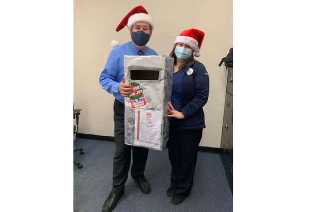Tesco stores are supporting this year's Comfort and Joy campaign buy housing postboxes for customers to place vouchers into. Pictured: Store manager Nigel Perman and community champion Jade Diamond from the Gosport Tesco store