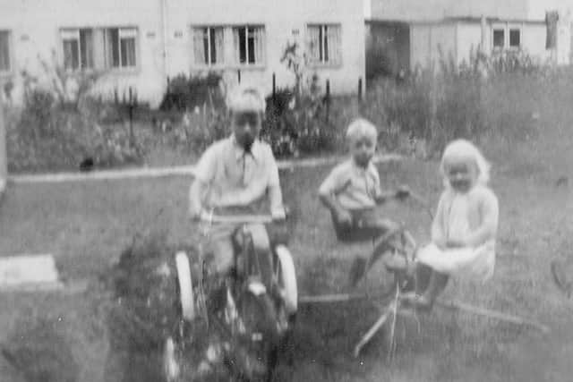 In the garden of 12, Botley Drive, Leigh Park. Overlooked by houses in Eversley Crescent, we see the Austwick children.