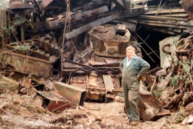Roger Allen standing in front of one of fifty tanks