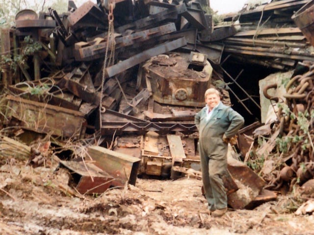 Roger Allen standing in front of one of fifty tanks