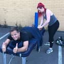 Keith Ashton gets a leg massage from Hannah Cronshaw during a brief break from the 12-hour endurance challenge