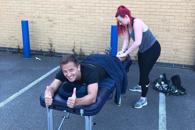 Keith Ashton gets a leg massage from Hannah Cronshaw during a brief break from the 12-hour endurance challenge