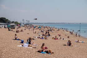 Pictured: People enjoying the sunshine on the beach