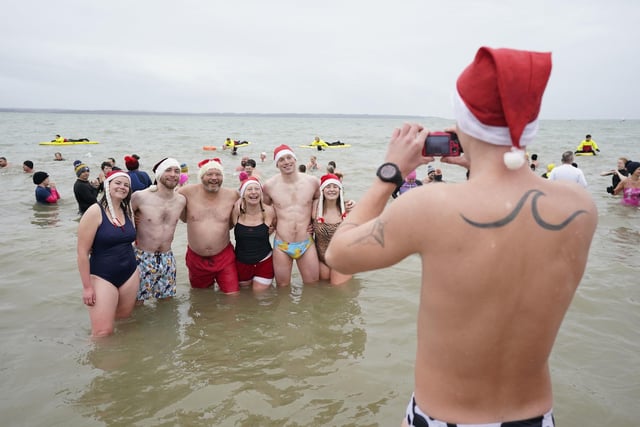 Swimmers pose for a photo during the Gosport New Year's Day Dip in The Solent at Stokes Bay, Gosport, Hampshire, to raise money for Gosport and Fareham Inshore Rescue Service.