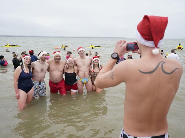 Swimmers pose for a photo during the Gosport New Year's Day Dip in The Solent at Stokes Bay, Gosport, Hampshire, to raise money for Gosport and Fareham Inshore Rescue Service.