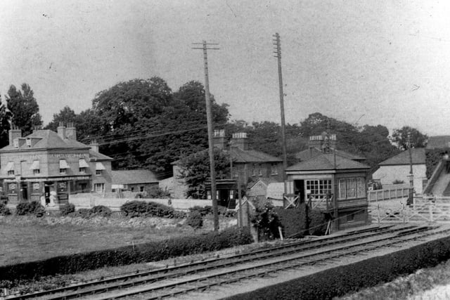 Cosham railway station approach in LBSC Railway days.. Very little remains to be seen today from this picture. The gates are now barriers and the signal box has  gone into history as well.
The Railway pub is now a block of flats and the goods yard is now covered in houses. Only the footbridge remains.
Even the photo cannot be retaken owing to a large block of flats being built in Portsmouth Road where the photographer was standing.