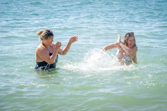 Friends Grace Osbourne and Lucy Wright having a splash fight in the sea in Old Portsmouth. Picture: Habibur Rahman