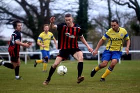Fleetlands striker Kelvin Robinson in action against Locks Heath. Simon Stone is on the right. Picture: Tom Phillips.