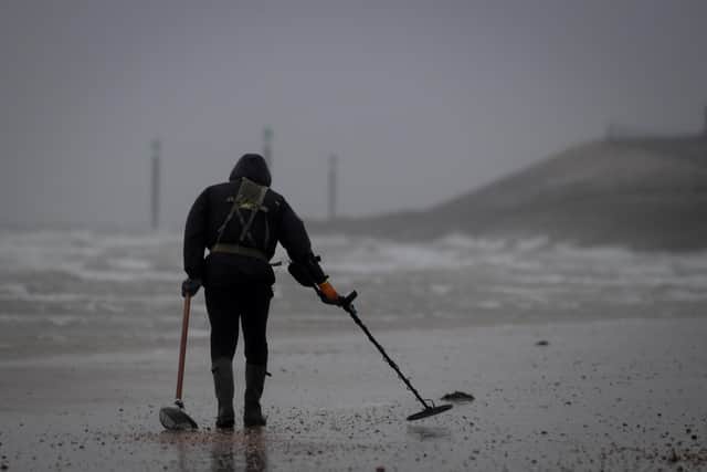A metal detectorist searches the shoreline on Southsea beach on February 16, 2022 in Southsea, England. Picture: Finnbarr Webster/Getty Images