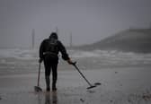A metal detectorist searches the shoreline on Southsea beach on February 16, 2022 in Southsea, England. Picture: Finnbarr Webster/Getty Images