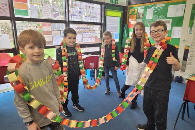(L to R) Jack Parker, 7, Charlie Harbert, 7, Dexter Tumber, 7, Scarlett Smith, 8 and Harry Johnson ,7, taking part in a competition to make the longest paper party chain.