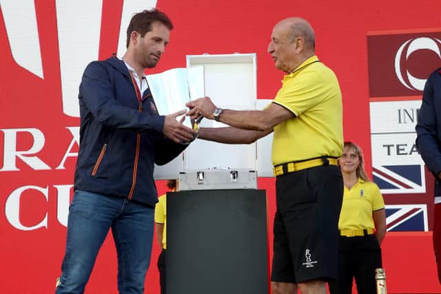 Ineos Team UK skipper Ben Ainslie is presented with the Christmas Cup after winning the Prada Cup round robin qualifying event. Photo by Phil Walter/Getty Images.