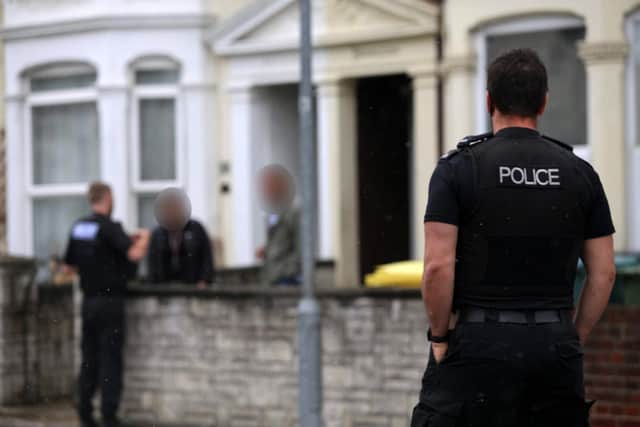 Police talk to residents in Derby Road, North End, Portsmouth. Picture: Habibur Rahman