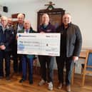 Captain Roy Valentine presenting his charity cheque to Ross Boon